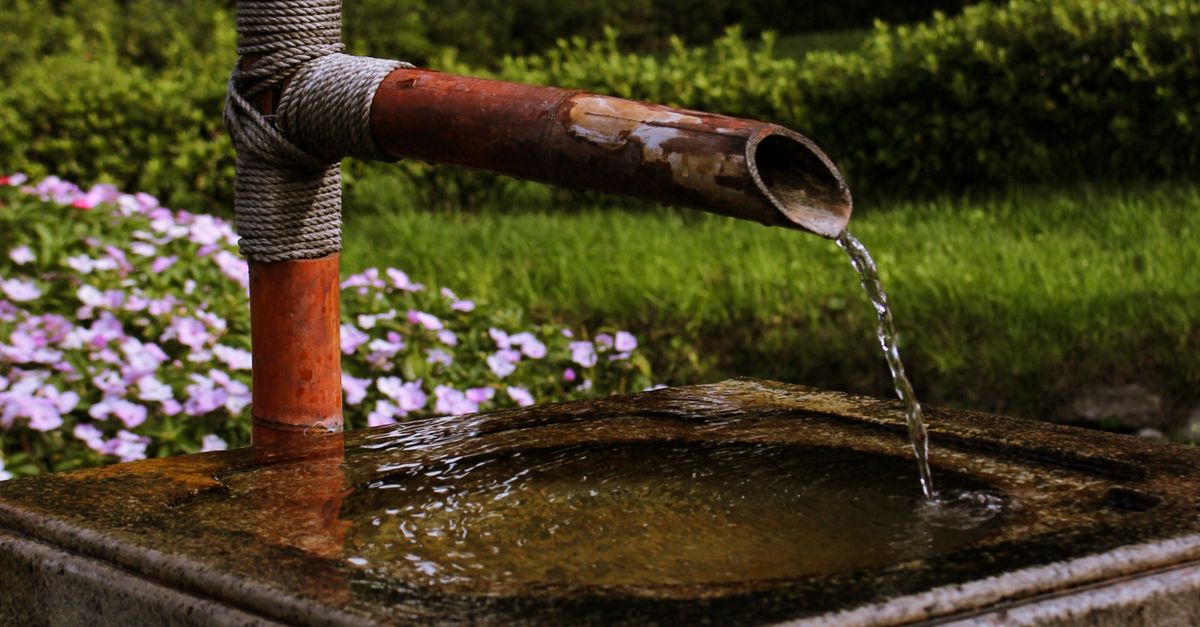 Water pouring from a rusted pipe
